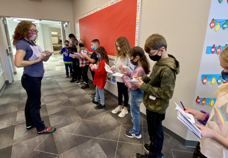 HOB art teacher Cherylyn Minto instructs students how to fill out their passports after traveling to each country. ELLEN DRISCOLL PHOTO